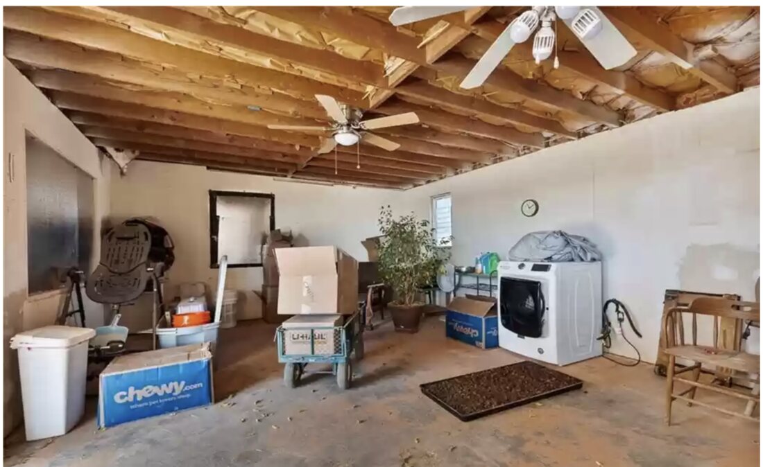 Before — the raw garage interior, now an ADU bedroom